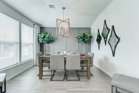 a view of a dining room with furniture and a potted plant