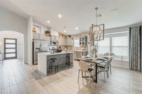 a kitchen with stainless steel appliances kitchen island granite countertop a sink and cabinets