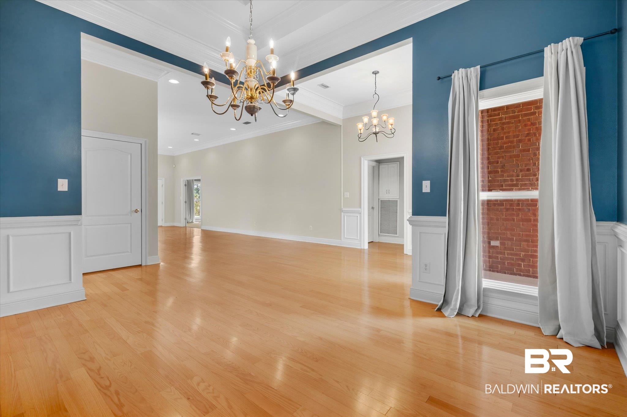 4109 Blue Heron Ridge Mobile, AL 36693 - Photo 11 of 33 Spare room with light wood-type flooring, a chandelier, and ornamental molding