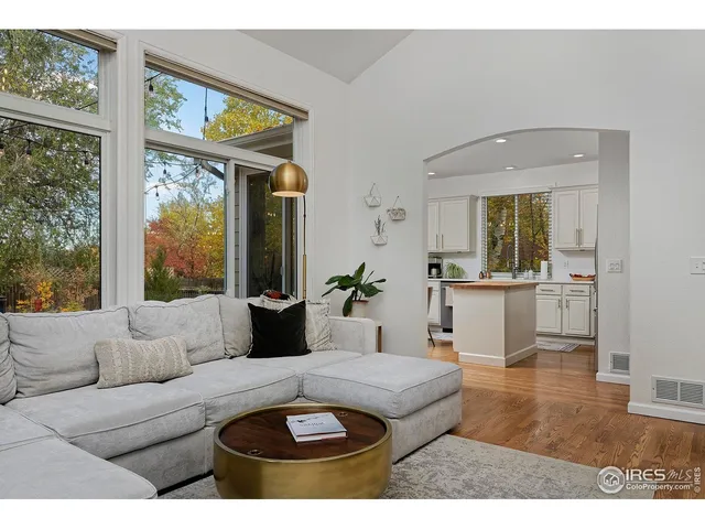 a living room with kitchen island granite countertop furniture a potted plant and a fireplace