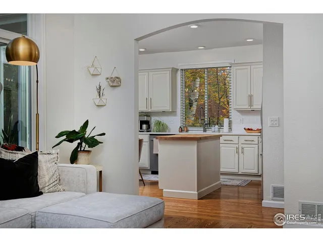 a kitchen with a stove a sink a microwave a dining table and chairs