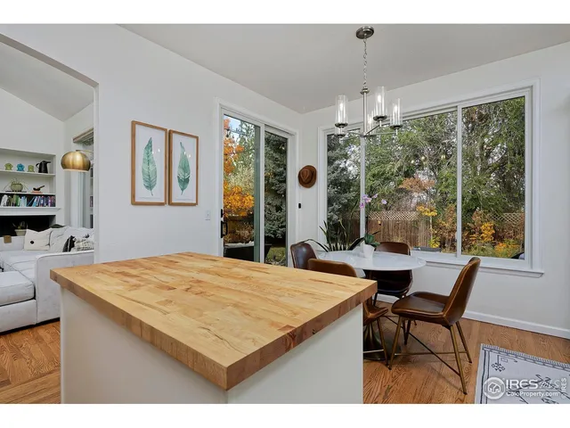 a dining room with furniture a chandelier and wooden floor