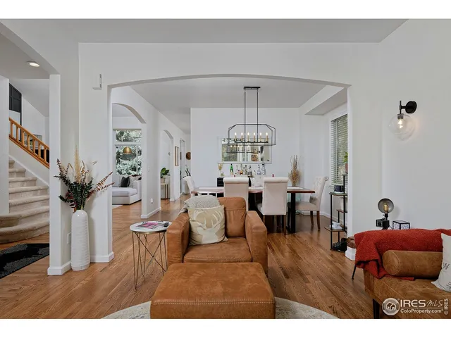 a view of a dining room with furniture wooden floor and chandelier