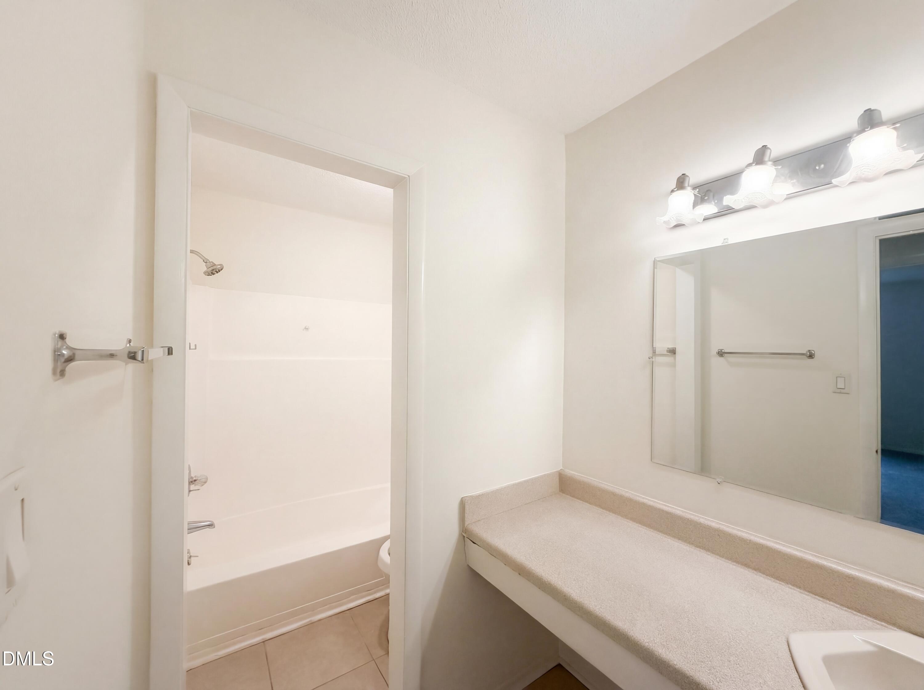 1220 Manassas Court, Unit B Raleigh, NC 27609 - Photo 27 of 32 a bathroom with a shower and a sink