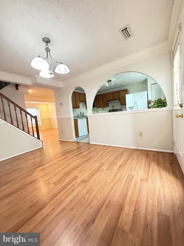 a view of a room with wooden floor
