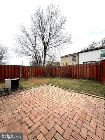 a view of a backyard with wooden fence