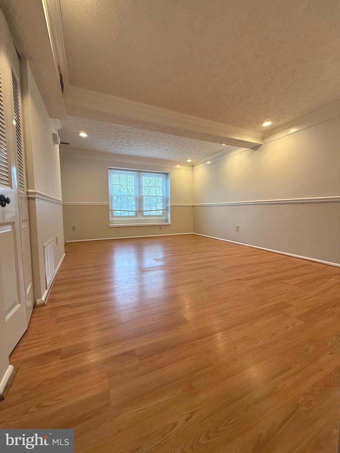 19445 Breezedale Lane Germantown, MD 20876 - Photo 3 of 16 an empty room with wooden floor and windows
