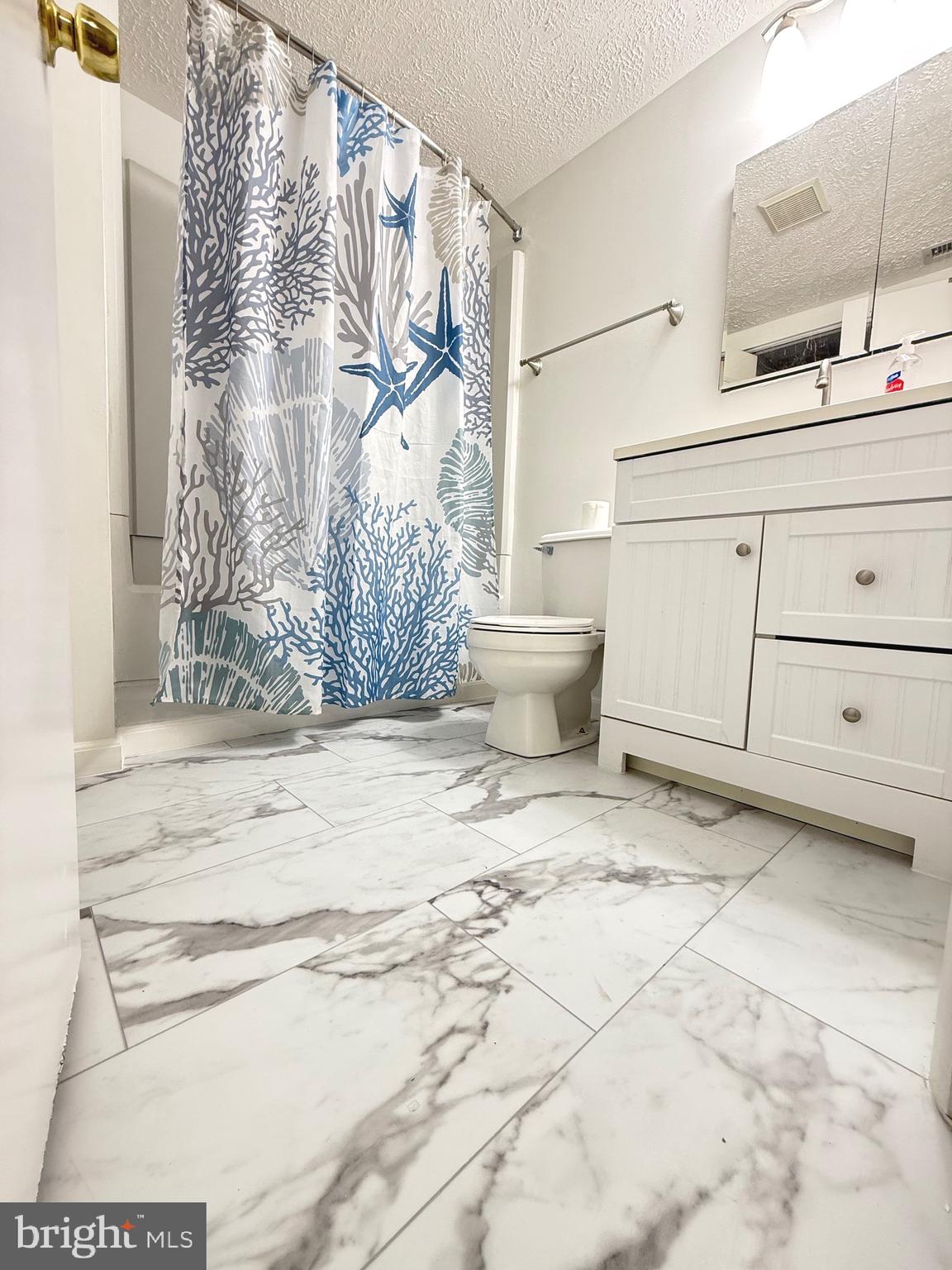 19445 Breezedale Lane Germantown, MD 20876 - Photo 8 of 16 a white bath tub sitting in a bathroom