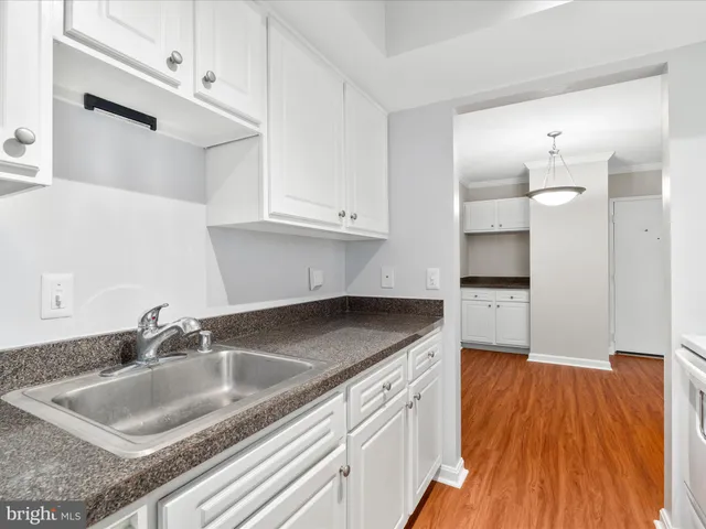 a kitchen with sink and cabinets