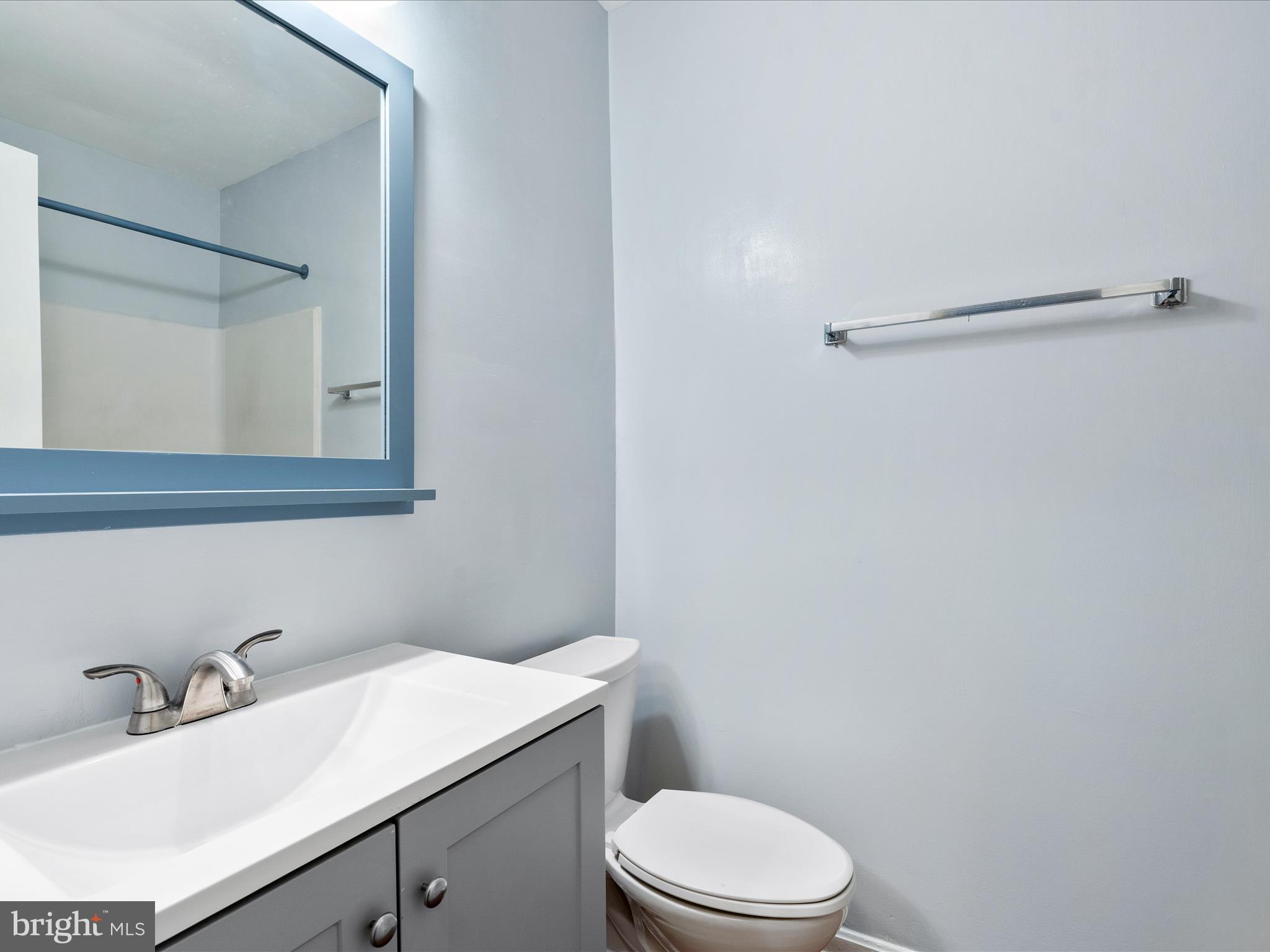18334 Streamside Drive, Unit 101 Gaithersburg, MD 20879 - Photo 20 of 29 a bathroom with a sink vanity mirror and toilet