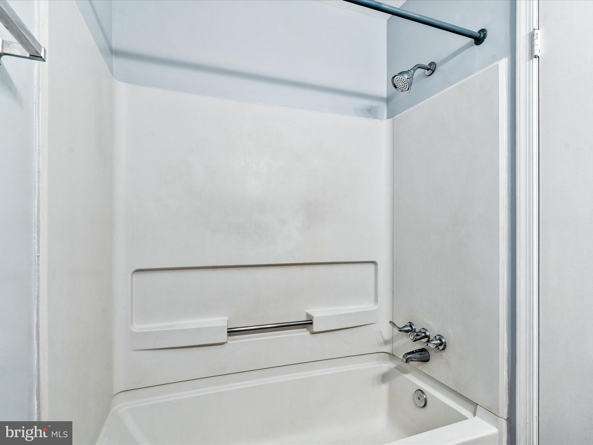 18334 Streamside Drive, Unit 101 Gaithersburg, MD 20879 - Photo 21 of 29 a bathroom with a white bath tub
