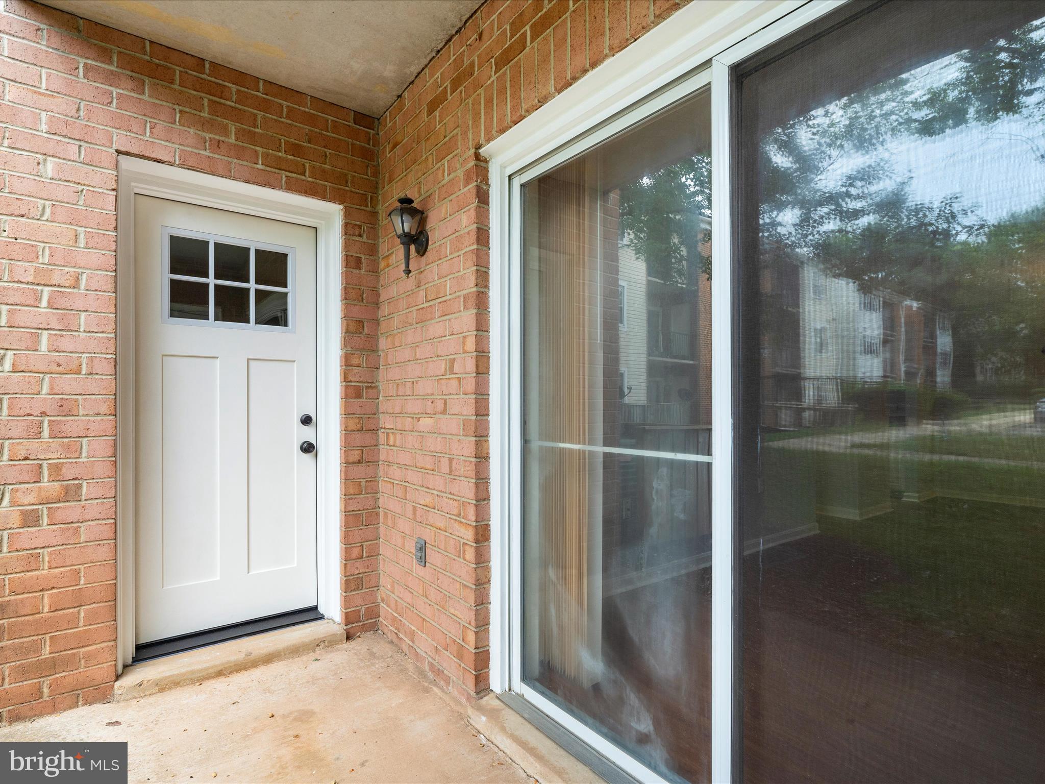 18334 Streamside Drive, Unit 101 Gaithersburg, MD 20879 - Photo 23 of 29 a view of a glass door with a glass door