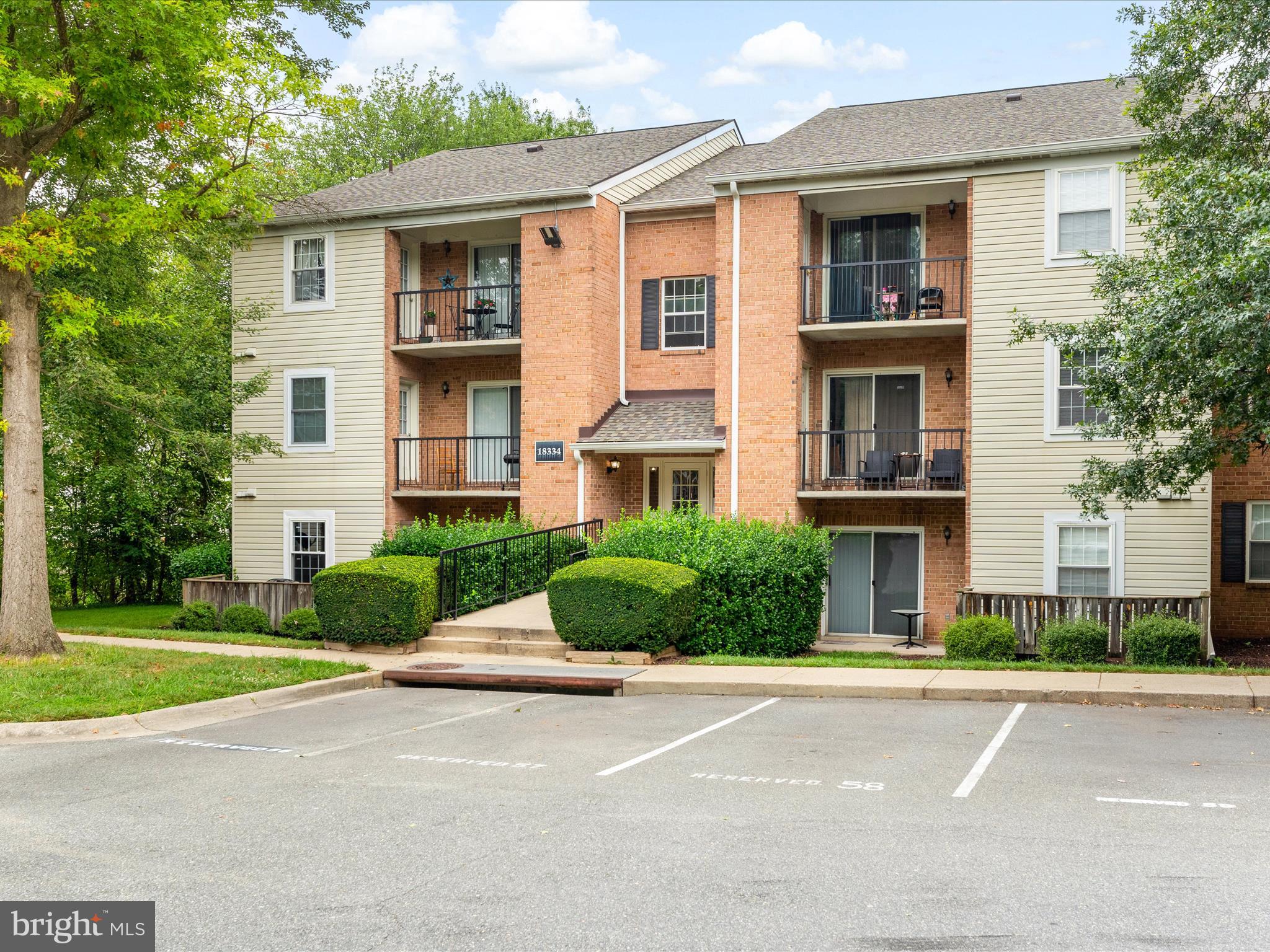 18334 Streamside Drive, Unit 101 Gaithersburg, MD 20879 - Photo 29 of 29 a front view of a house with a yard