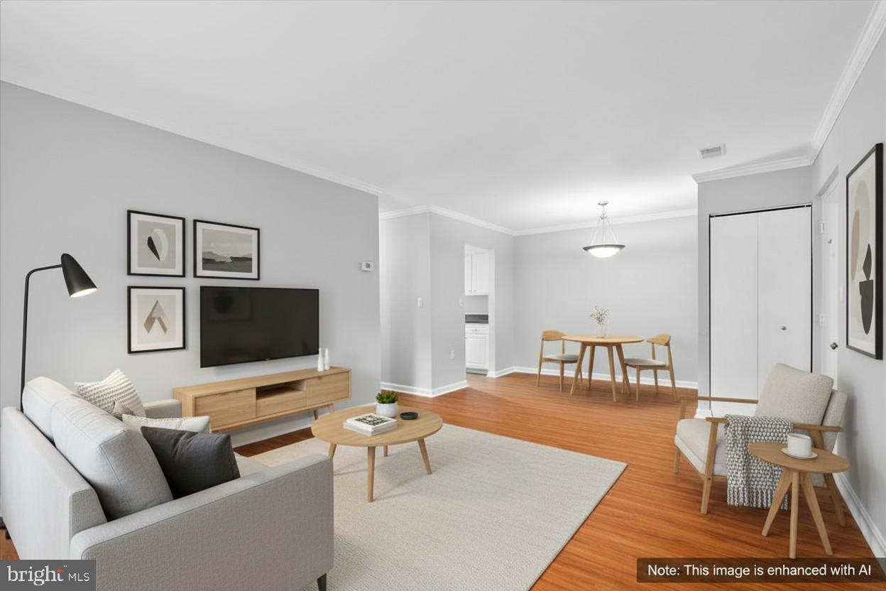 18334 Streamside Drive, Unit 101 Gaithersburg, MD 20879 - Photo 5 of 29 a living room with furniture and a flat screen tv