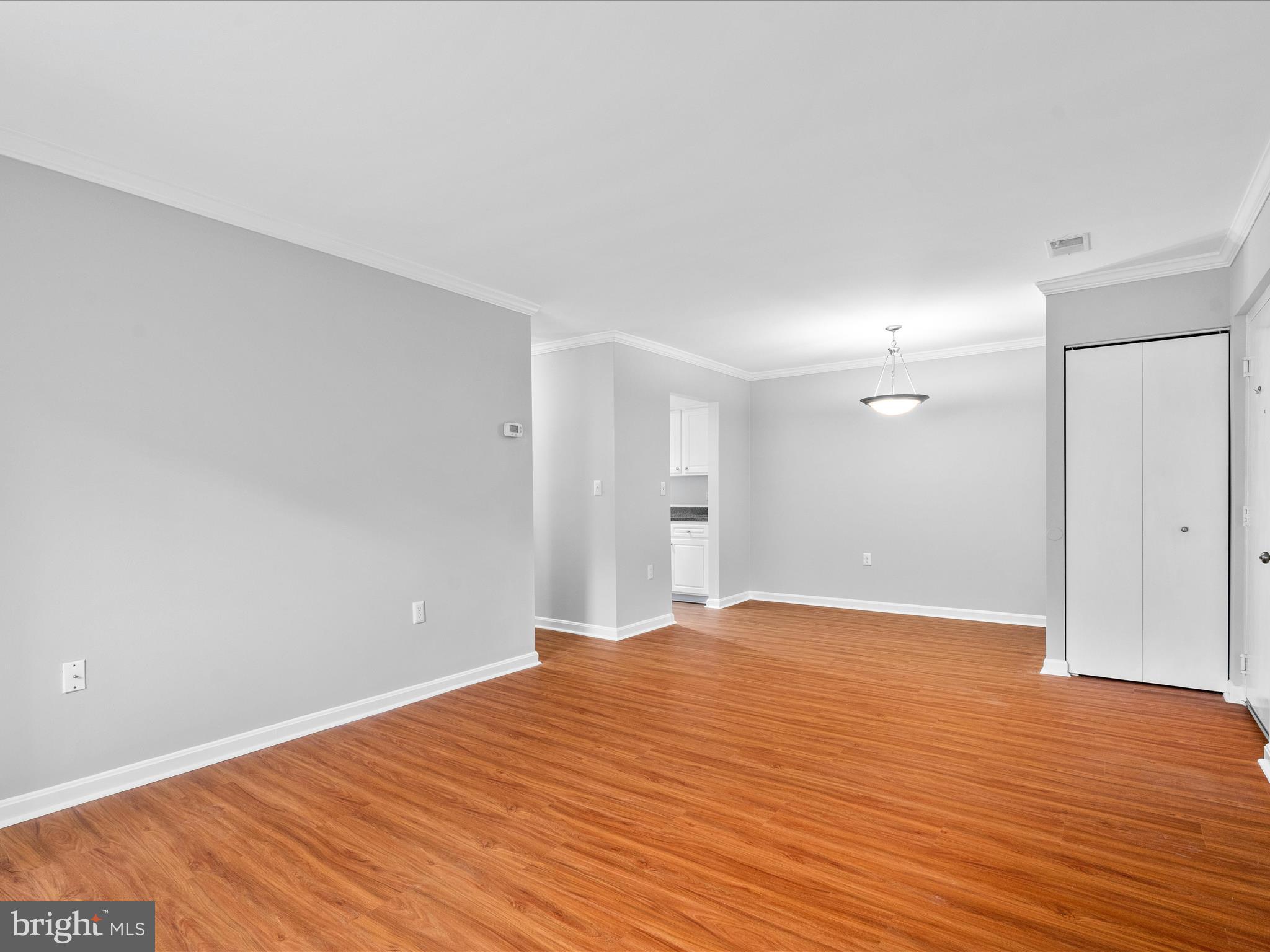 18334 Streamside Drive, Unit 101 Gaithersburg, MD 20879 - Photo 6 of 29 a view of empty room with wooden floor