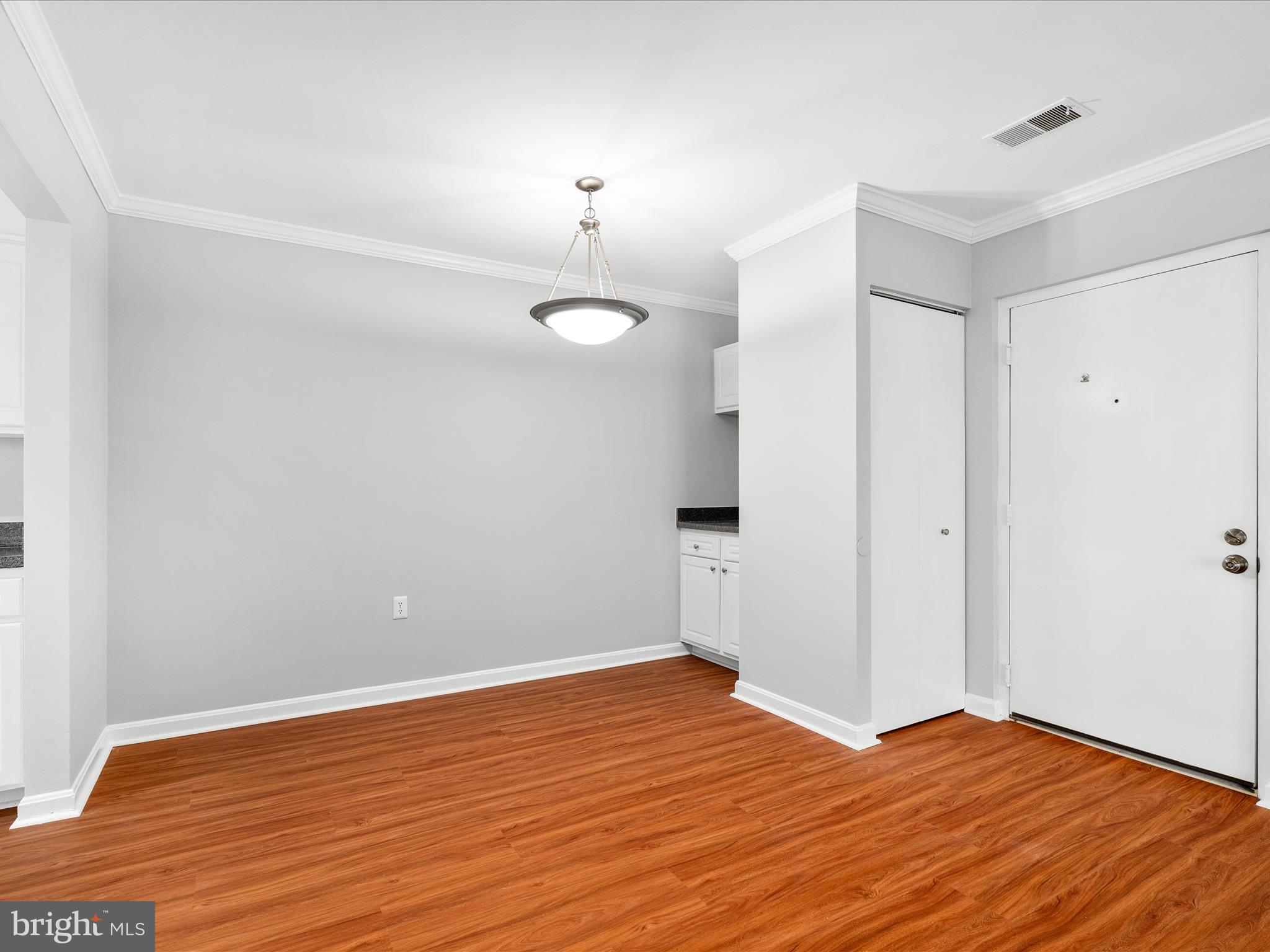 18334 Streamside Drive, Unit 101 Gaithersburg, MD 20879 - Photo 7 of 29 a view of empty room with wooden floor and fan