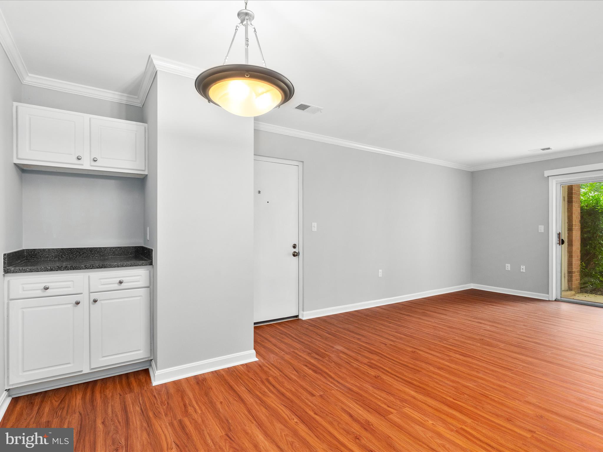 18334 Streamside Drive, Unit 101 Gaithersburg, MD 20879 - Photo 8 of 29 a view of an empty room with wooden floor