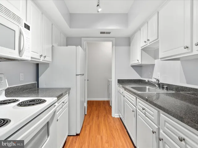 a kitchen with a sink a stove and refrigerator