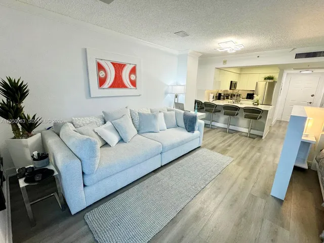 a living room with furniture window and wooden floor