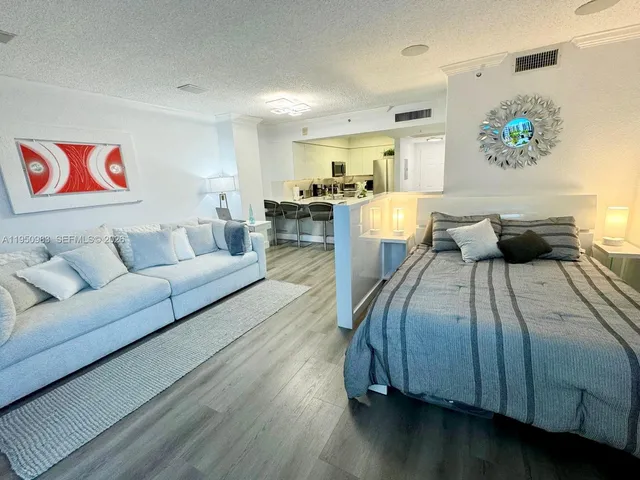 a living room with furniture and painting on the wall