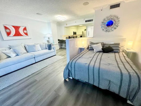 a bedroom with a bed and a couch