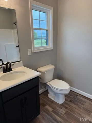 a bathroom with a sink toilet and window