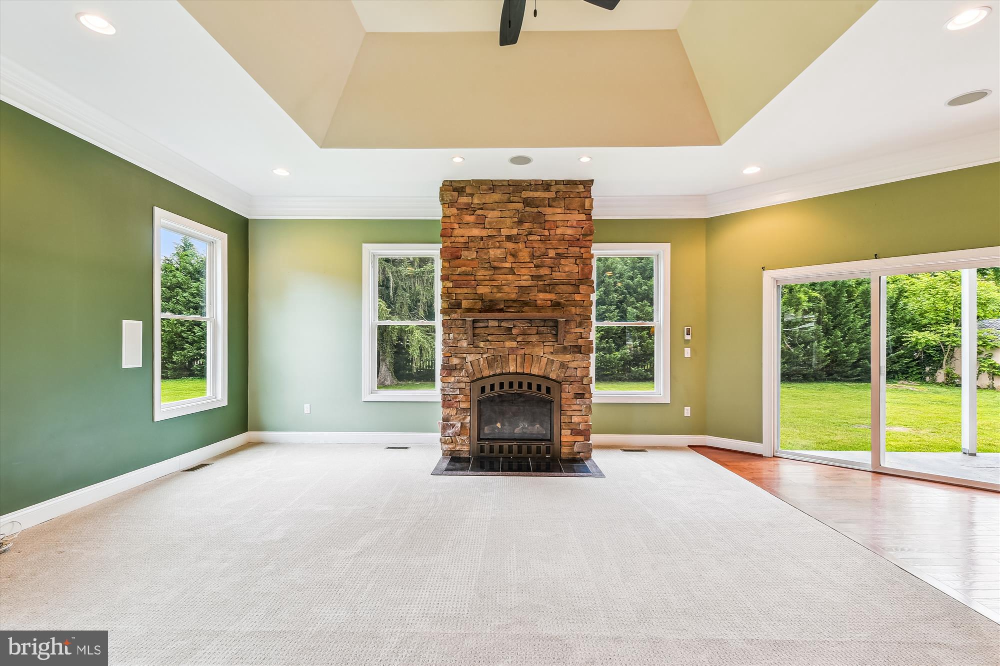 222 Wicklow Road Glen Burnie, MD 21061 - Photo 13 of 39 a view of an empty room with a fireplace and a window