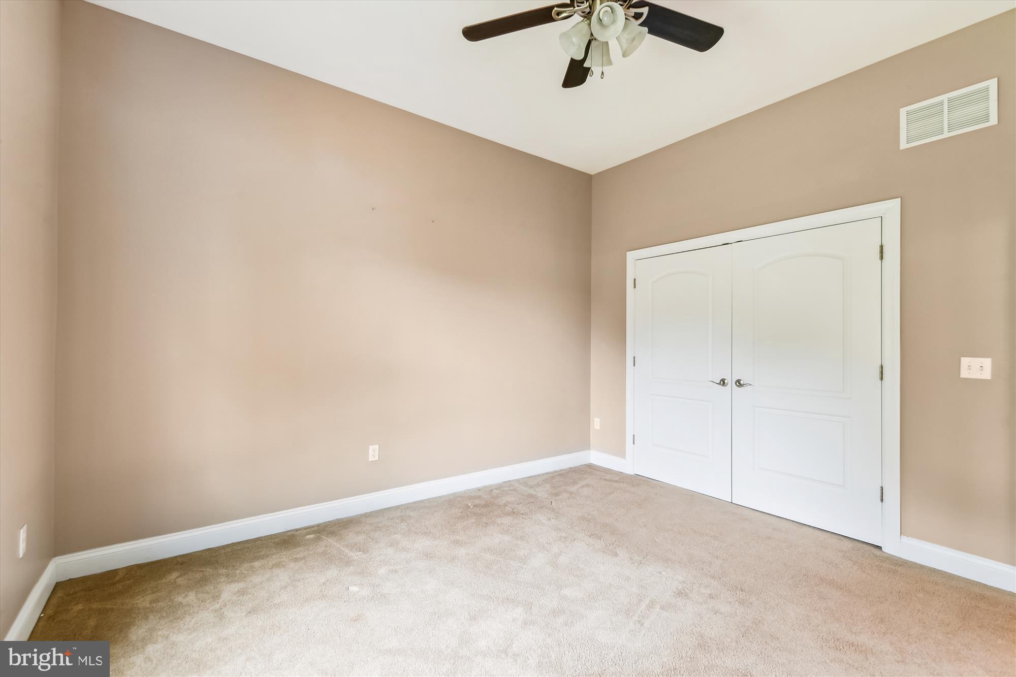 222 Wicklow Road Glen Burnie, MD 21061 - Photo 27 of 39 an empty room with a ceiling fan and carpet