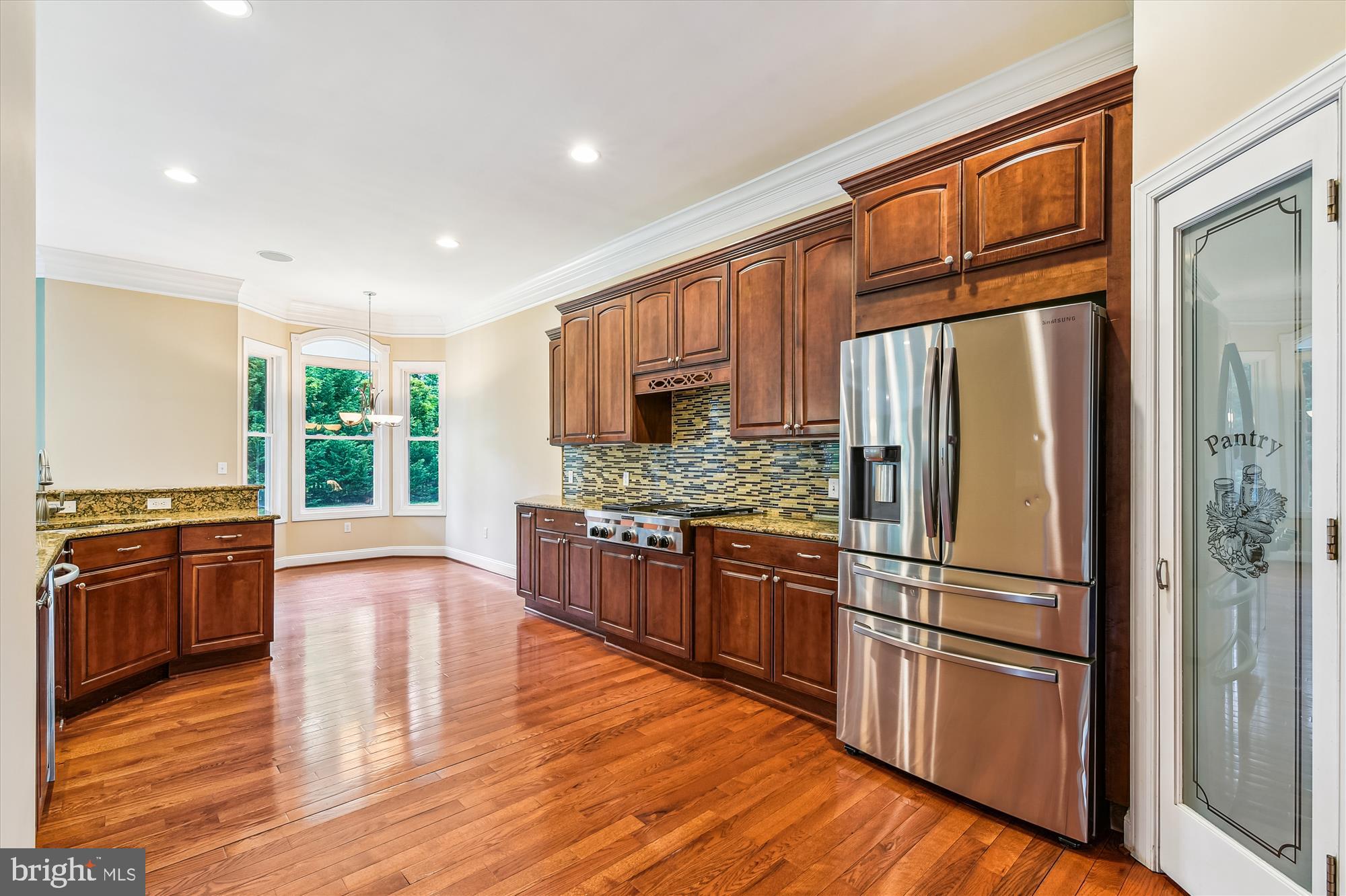 222 Wicklow Road Glen Burnie, MD 21061 - Photo 4 of 39 a kitchen with granite countertop wooden floors stainless steel appliances and a window