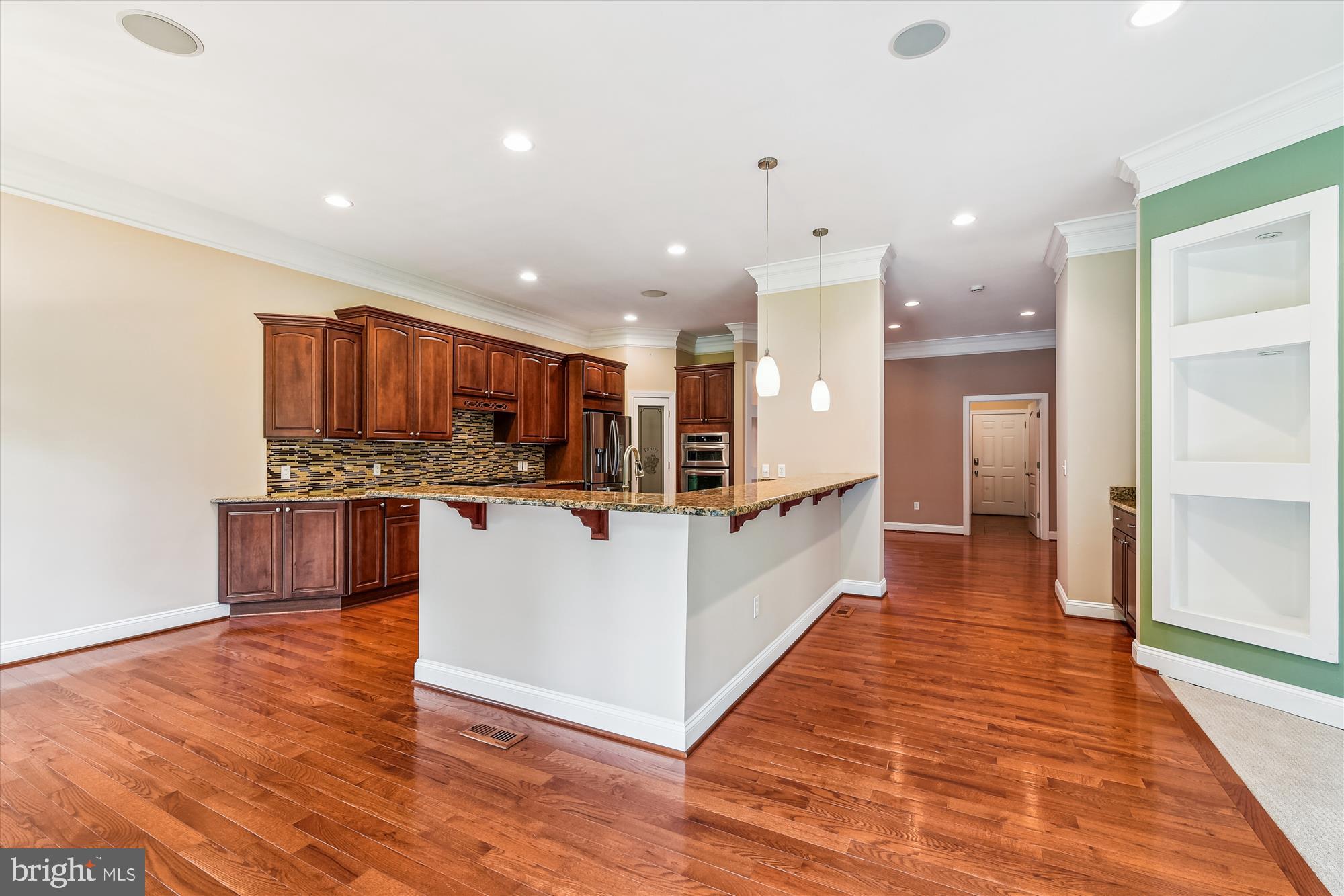 222 Wicklow Road Glen Burnie, MD 21061 - Photo 5 of 39 a large white kitchen with kitchen island a island wooden floor and a sink