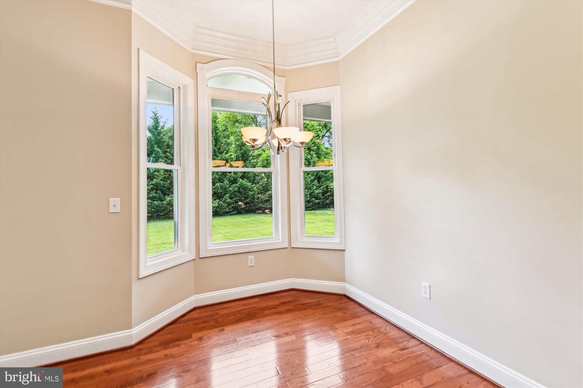 222 Wicklow Road Glen Burnie, MD 21061 - Photo 7 of 39 a view of an empty room with wooden floor and a window