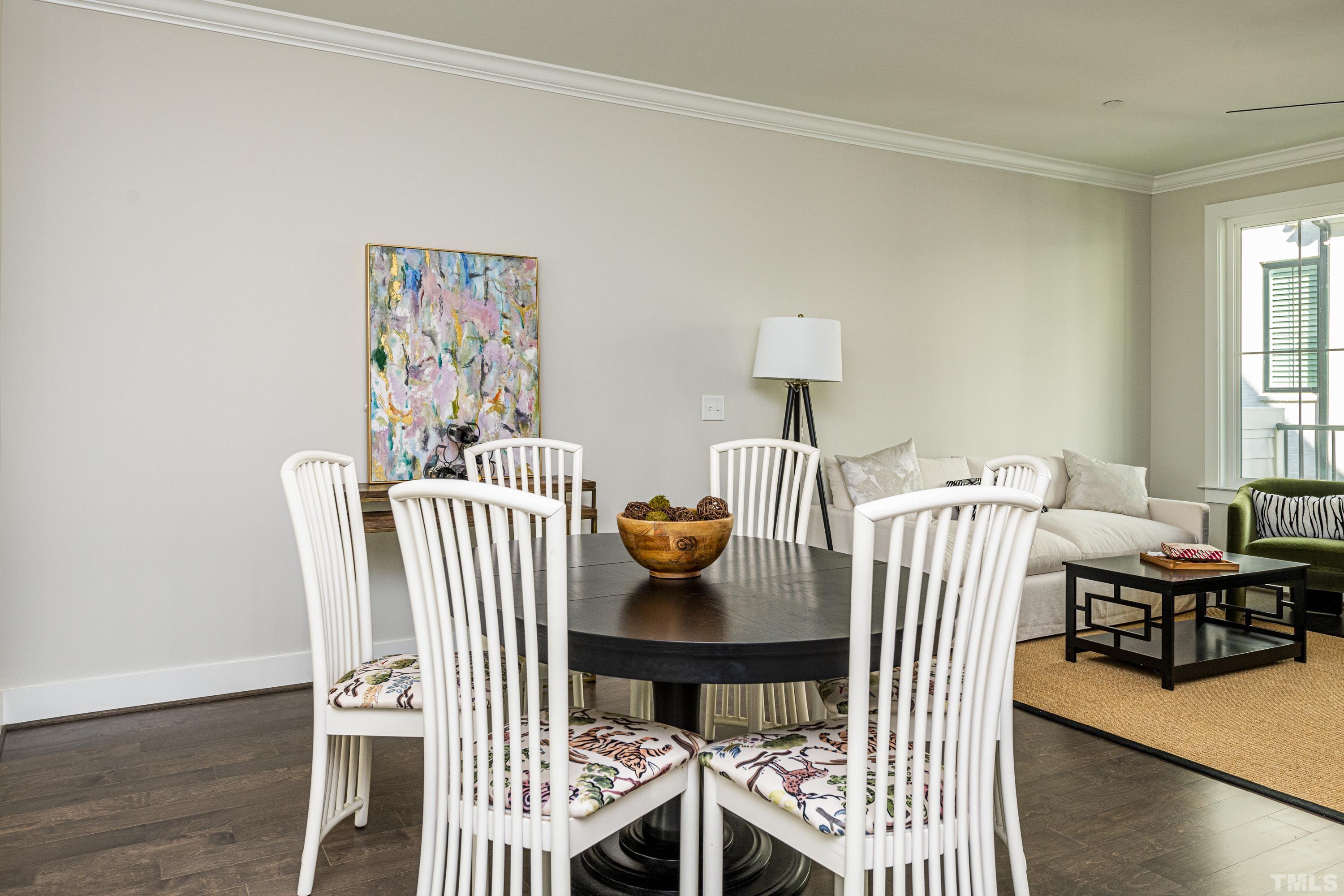 401 Bryan Pointe Drive, Unit 102 Raleigh, NC 27608 - Photo 12 of 30 a view of a dining room with furniture and wooden floor