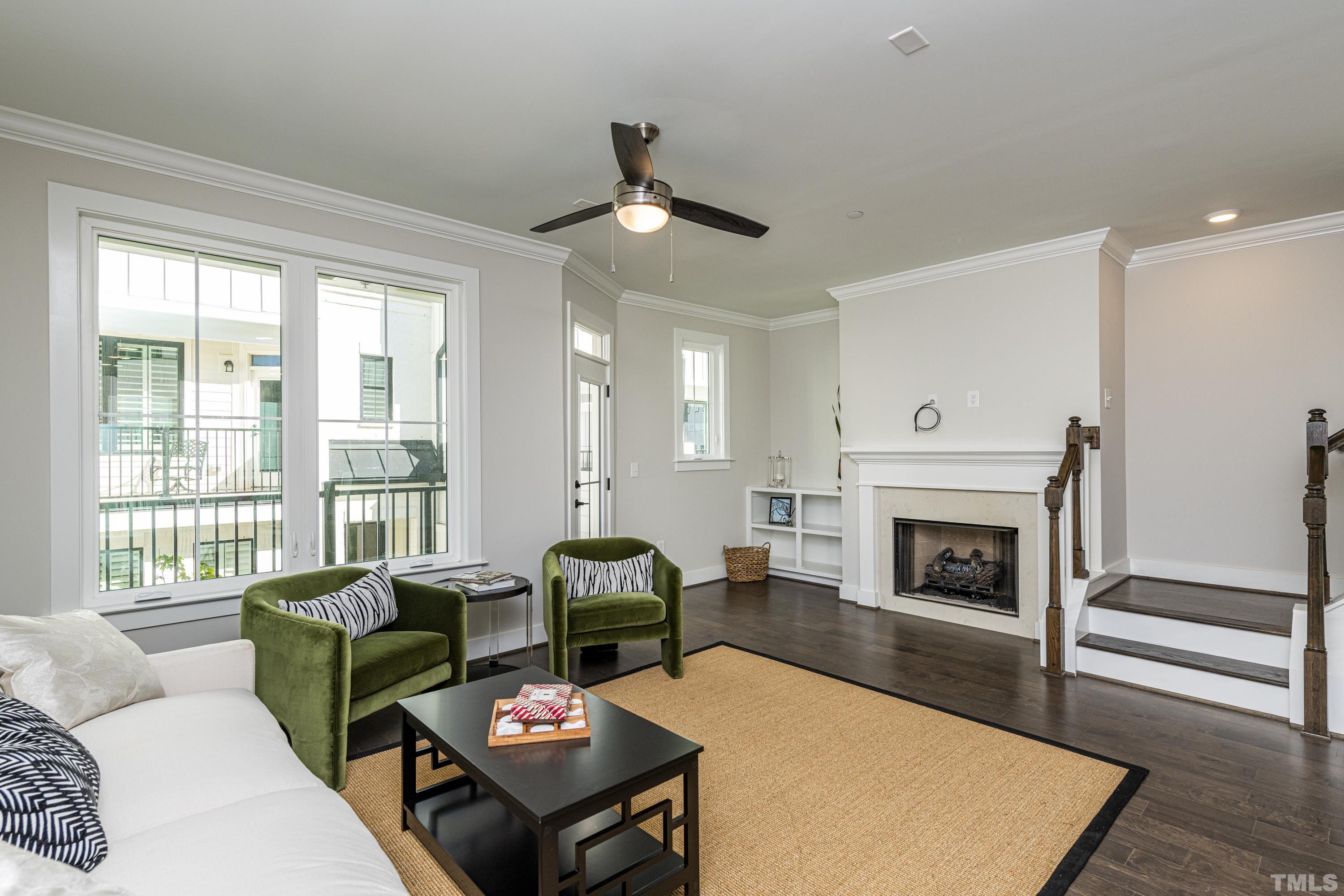 401 Bryan Pointe Drive, Unit 102 Raleigh, NC 27608 - Photo 15 of 30 a living room with furniture a fireplace and a large window