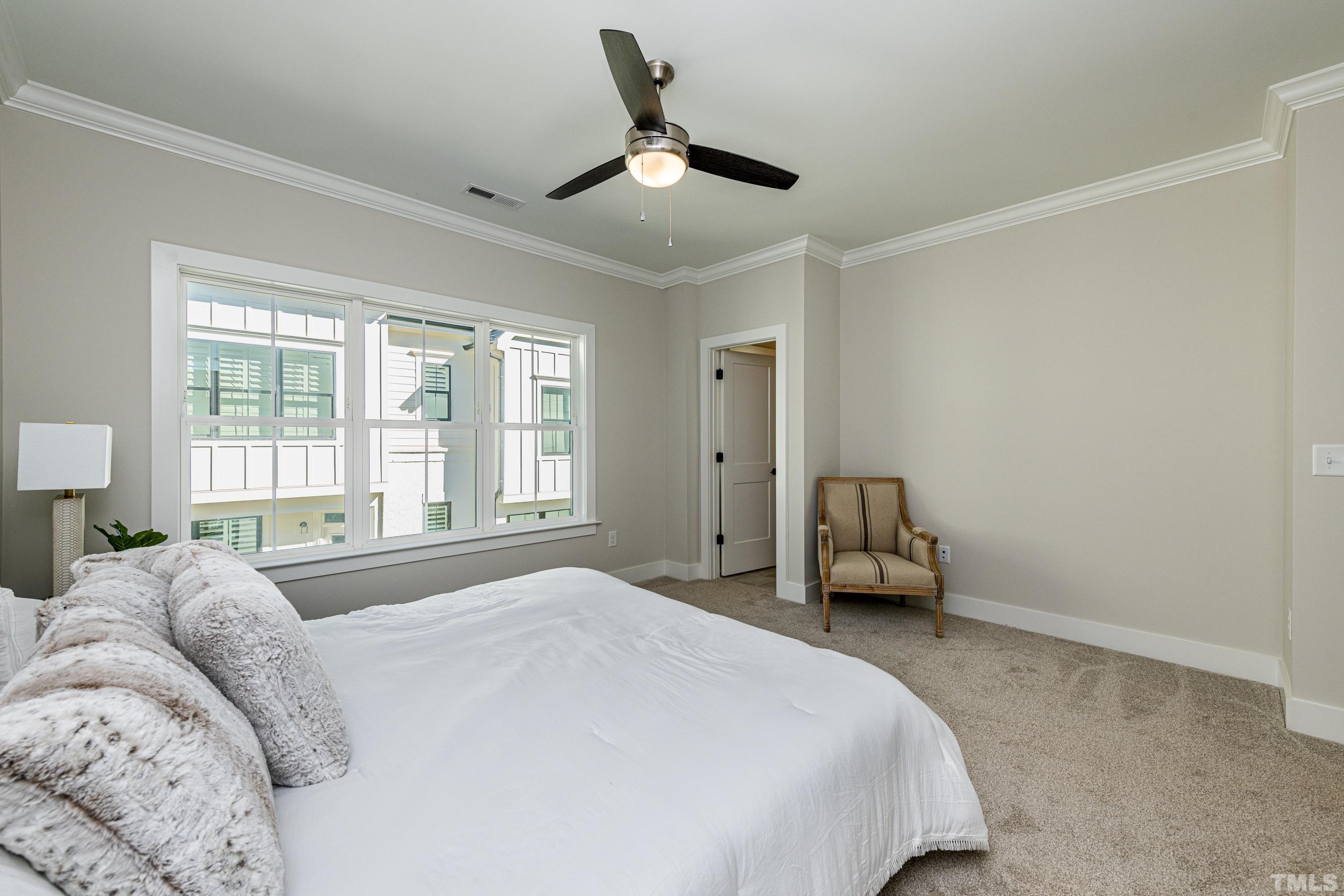 401 Bryan Pointe Drive, Unit 102 Raleigh, NC 27608 - Photo 21 of 30 a bedroom with a bed and a large window