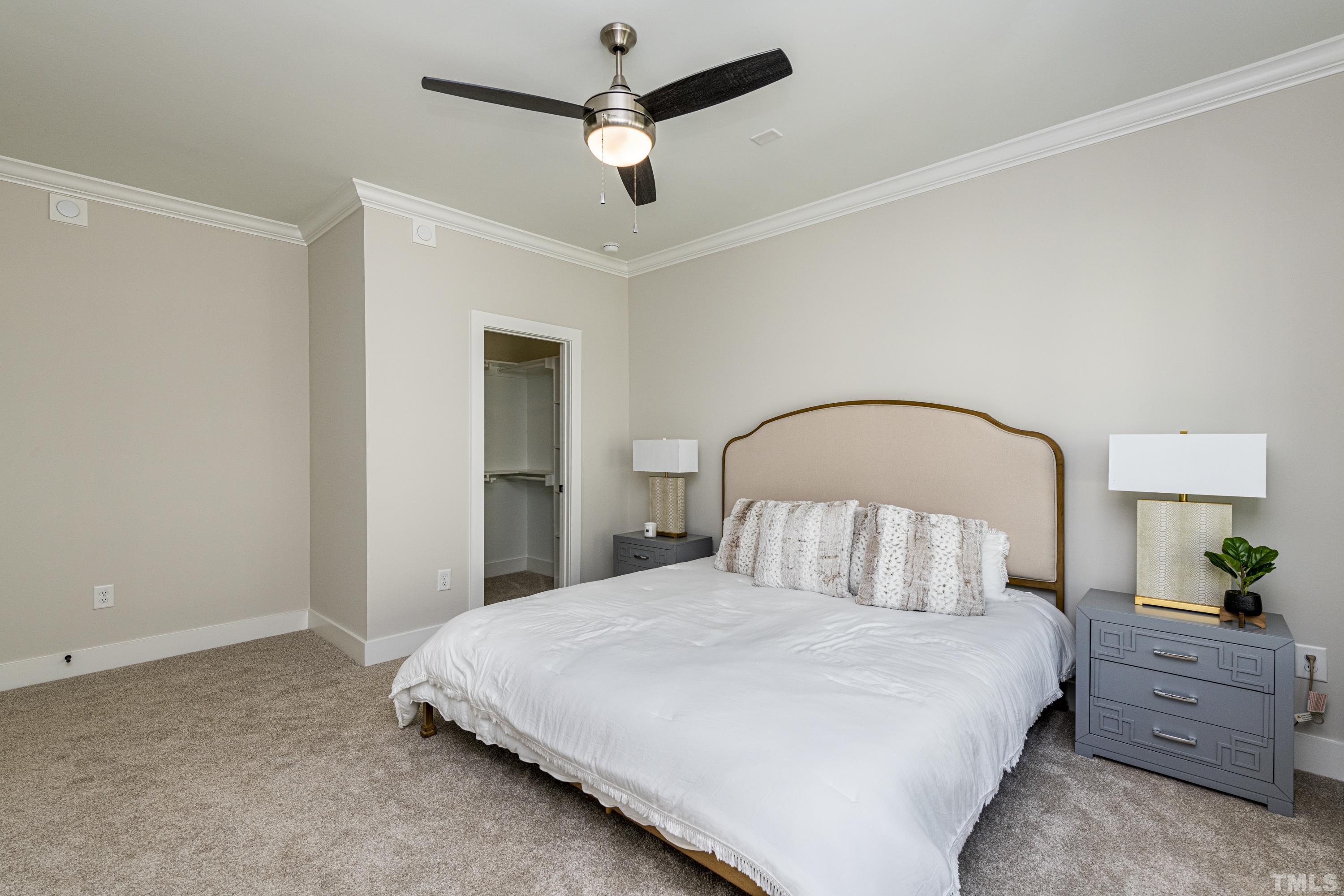 401 Bryan Pointe Drive, Unit 102 Raleigh, NC 27608 - Photo 22 of 30 a bedroom with a bed and a ceiling fan