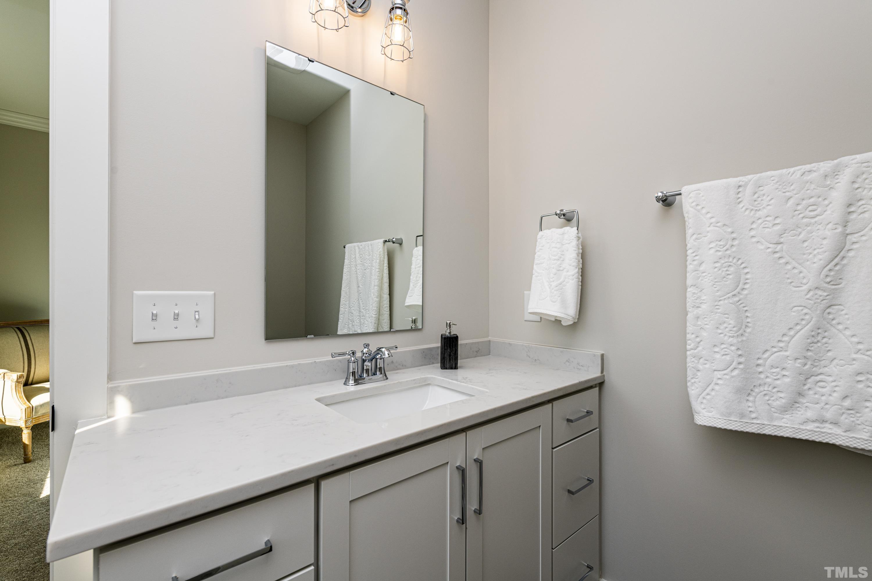 401 Bryan Pointe Drive, Unit 102 Raleigh, NC 27608 - Photo 28 of 30 a bathroom with a sink double vanity and a mirror