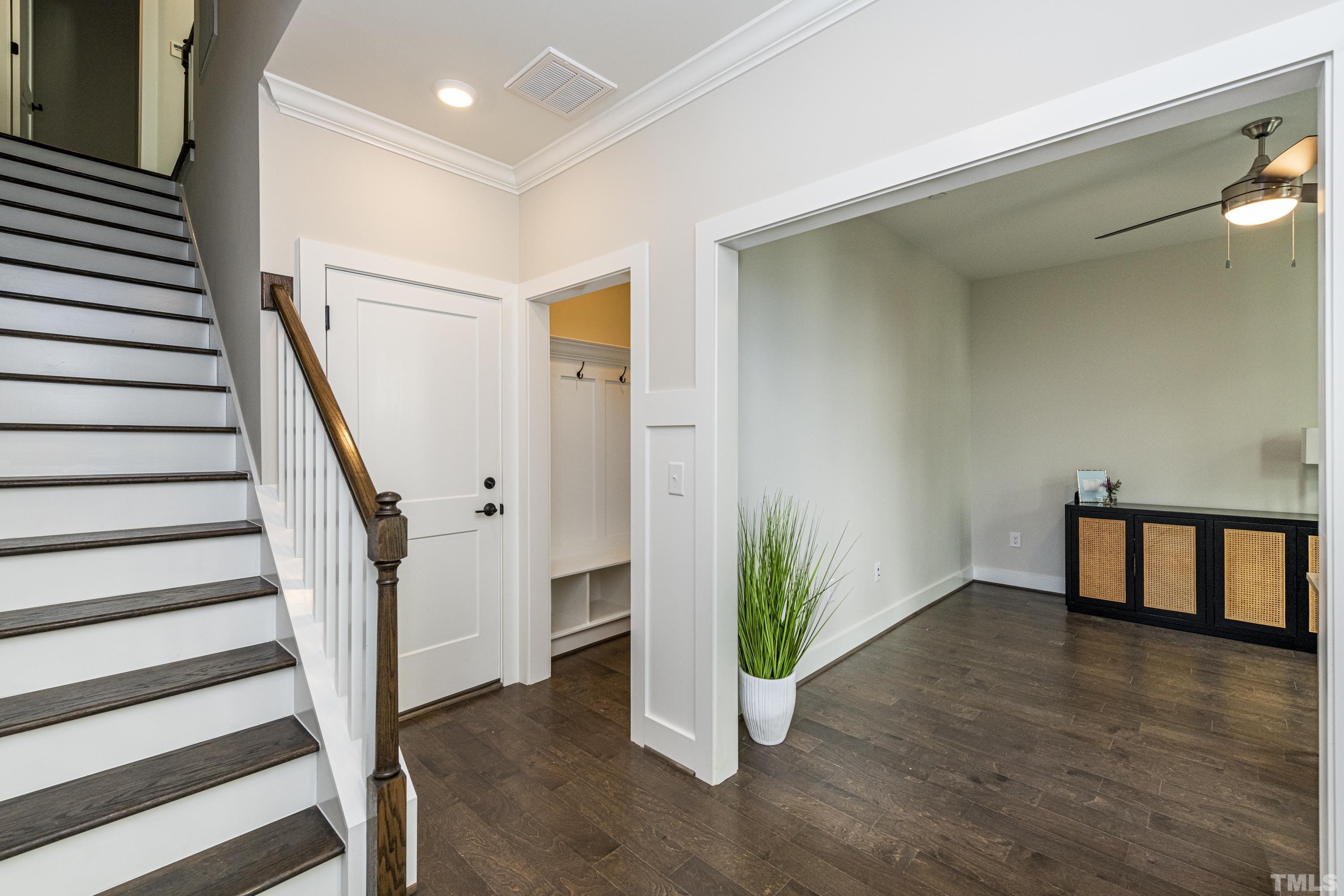 401 Bryan Pointe Drive, Unit 102 Raleigh, NC 27608 - Photo 4 of 30 a view of entryway with wooden floor and stairs