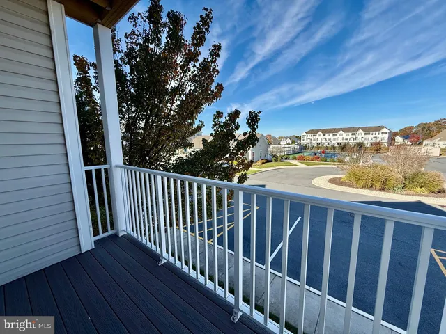 a view of a balcony with wooden floor and fence