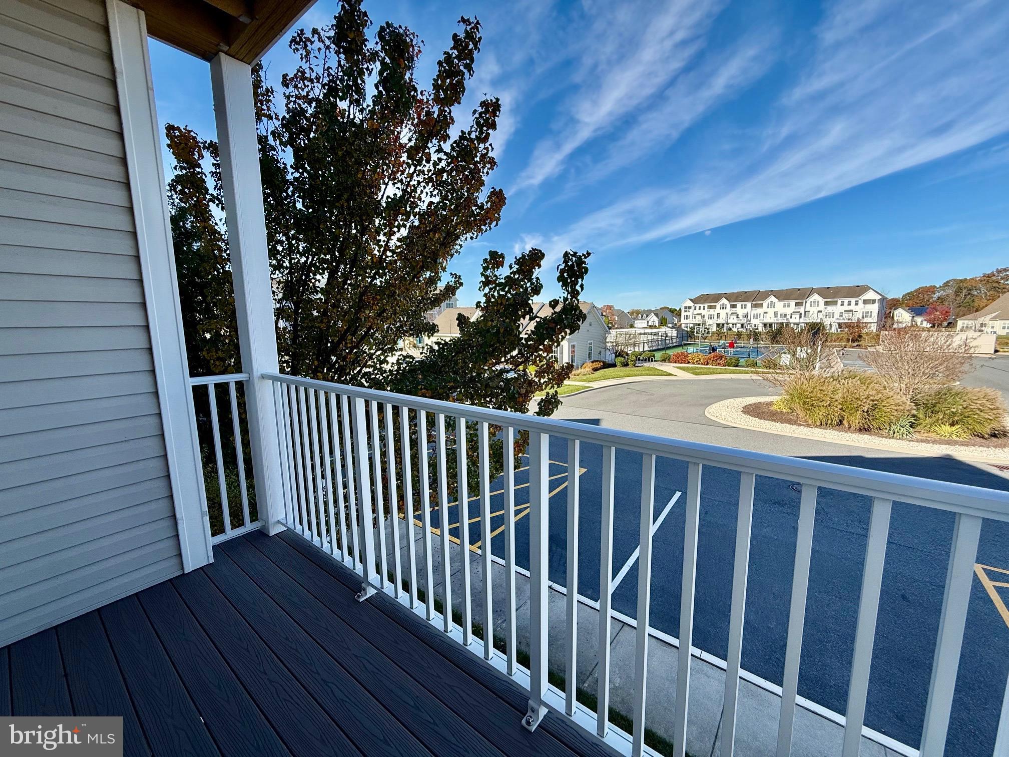 a view of a balcony with wooden floor and fence