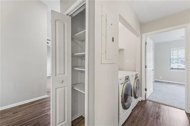 a view of a hallway with washer and dryer