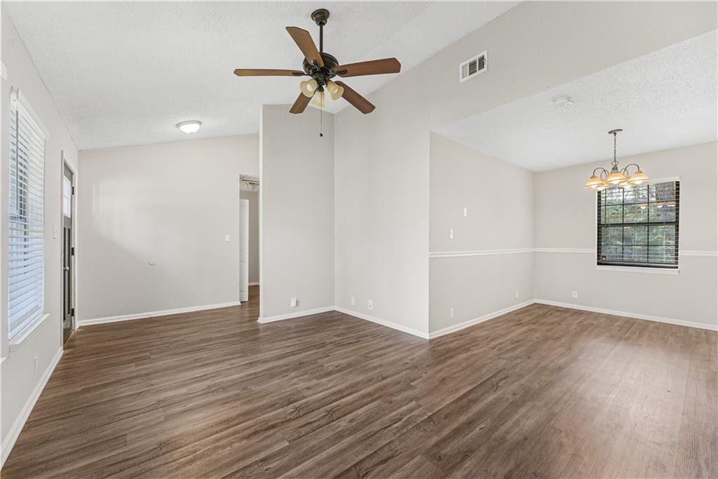 3511 Misty Valley Road Decatur, GA 30032 - Photo 6 of 16 an empty room with wooden floor ceiling fan and windows