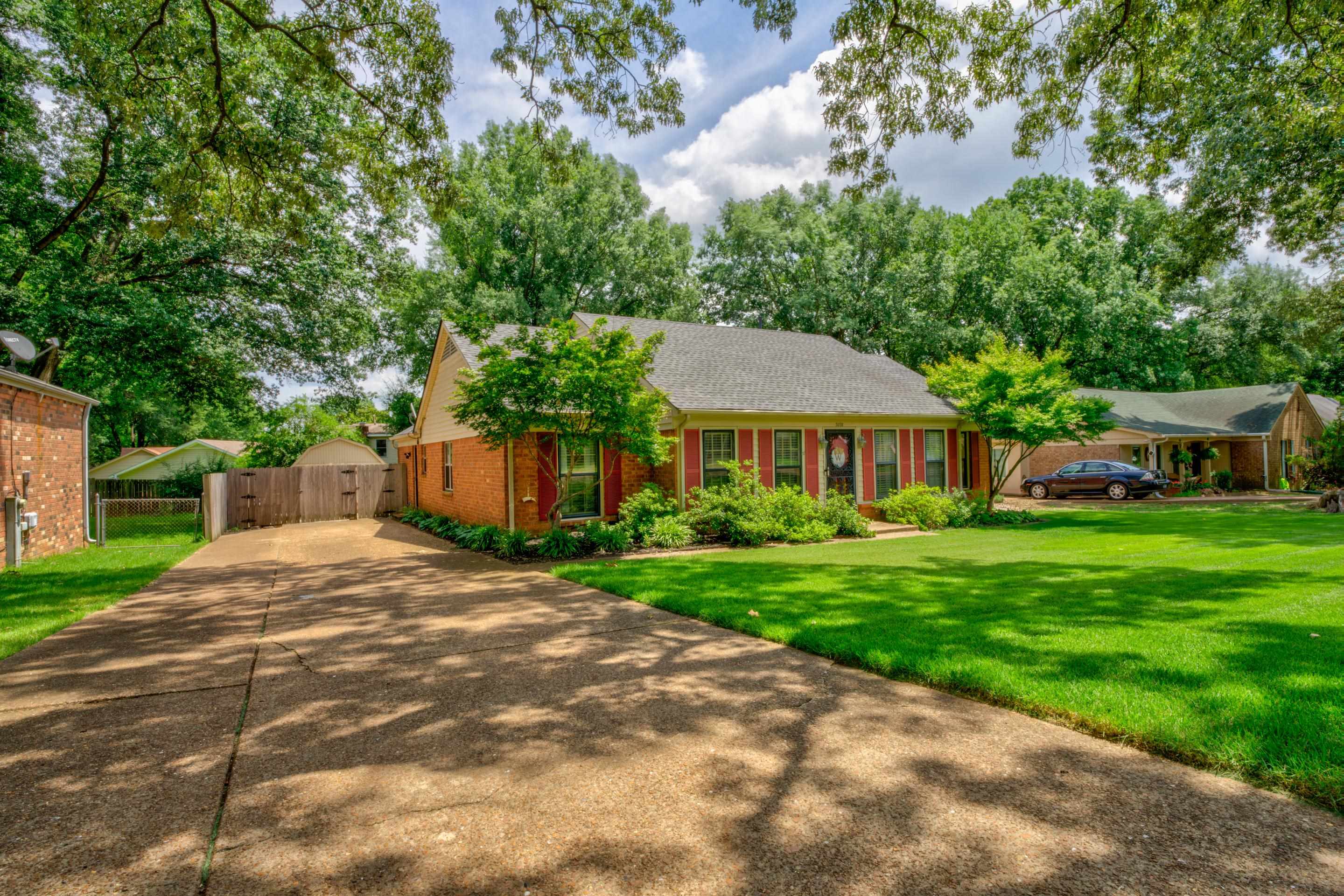 3078 Altruria Road Bartlett, TN 38134 - Photo 20 of 21 a front view of a house with a garden and trees