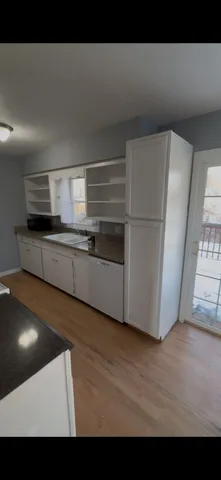a view of kitchen with furniture and wooden floor