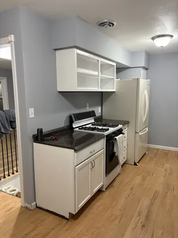 a kitchen with stainless steel appliances a sink and a refrigerator