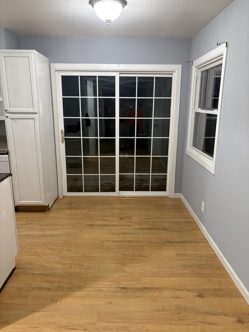 2919 Meadowbrook Drive Clinton, IA 52732 - Photo 4 of 12 a view of an empty room with wooden floor and a window