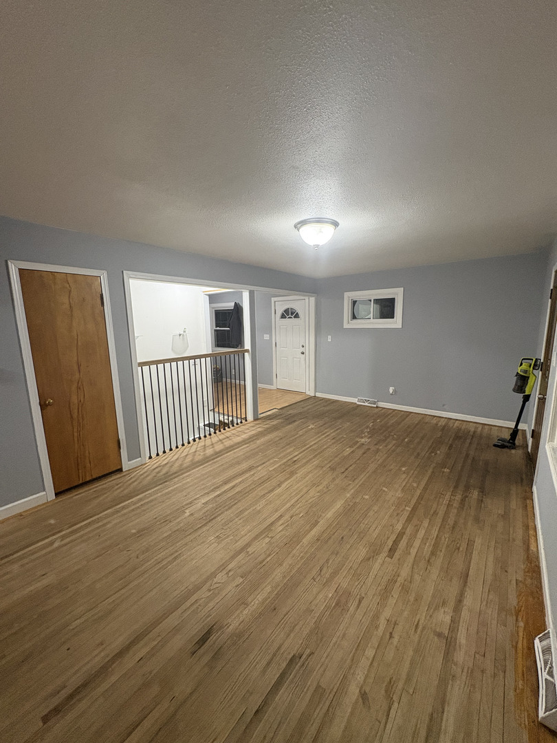 2919 Meadowbrook Drive Clinton, IA 52732 - Photo 6 of 12 a view of a livingroom with wooden floor and staircase