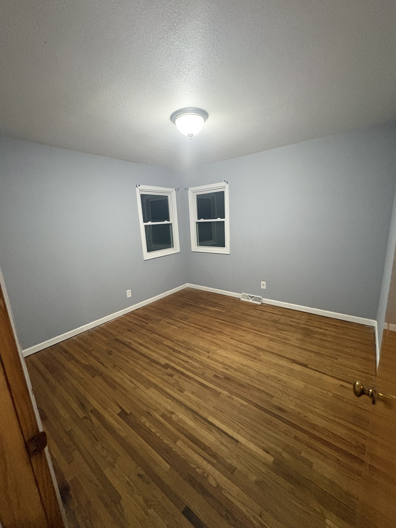 2919 Meadowbrook Drive Clinton, IA 52732 - Photo 7 of 12 a view of empty room with wooden floor