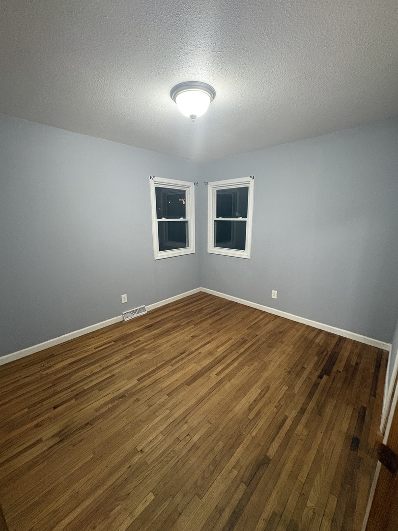 2919 Meadowbrook Drive Clinton, IA 52732 - Photo 9 of 12 a view of empty room with wooden floor and fan