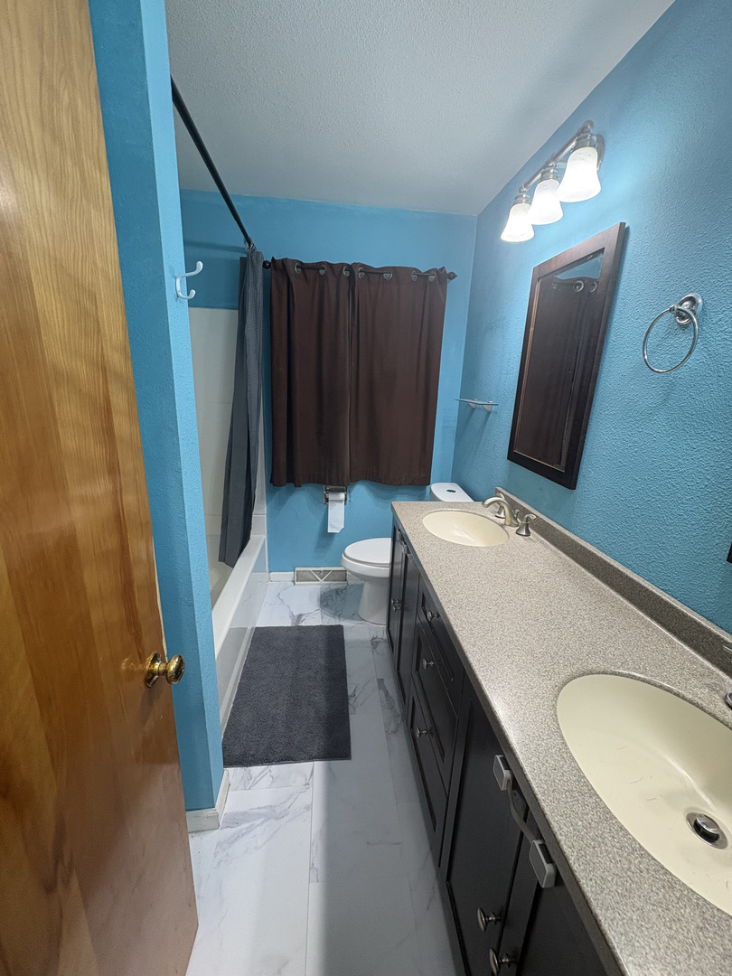 2919 Meadowbrook Drive Clinton, IA 52732 - Photo 10 of 12 a bathroom with a sink a vanity and a mirror