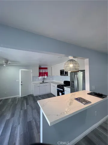 a view of kitchen and hall with wooden floor